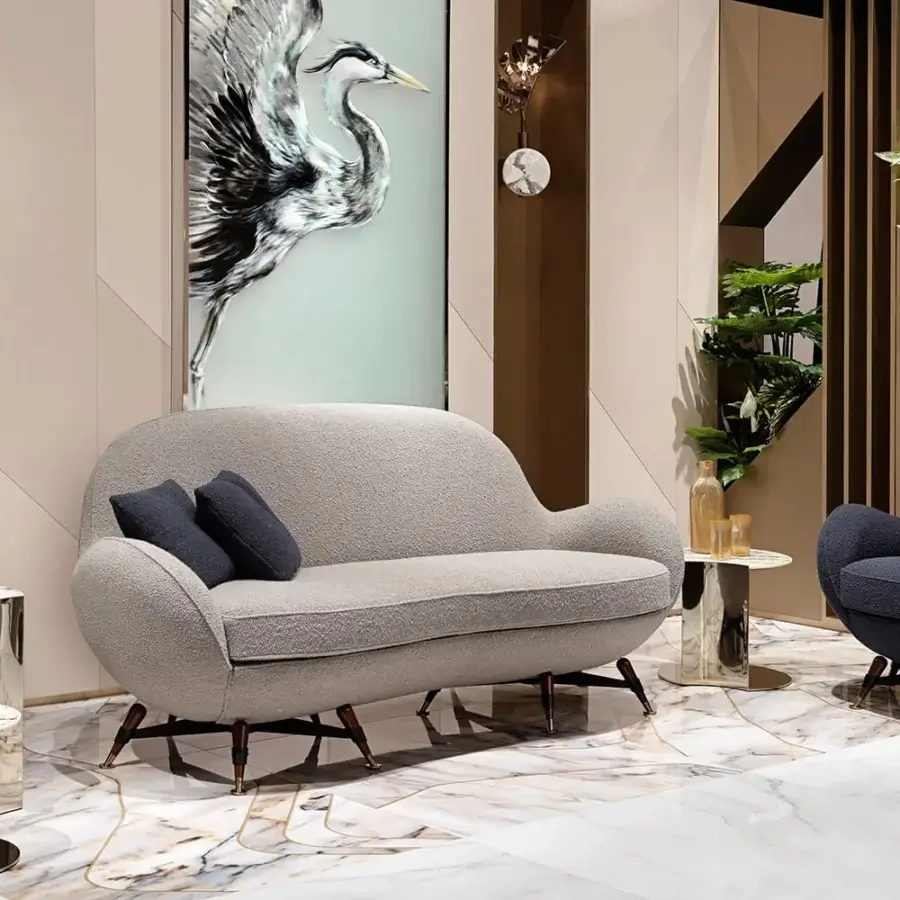 Elegant Visionnaire Mercury sofa with gently curved form upholstered in textured light gray stretch fabric and matte black steel base