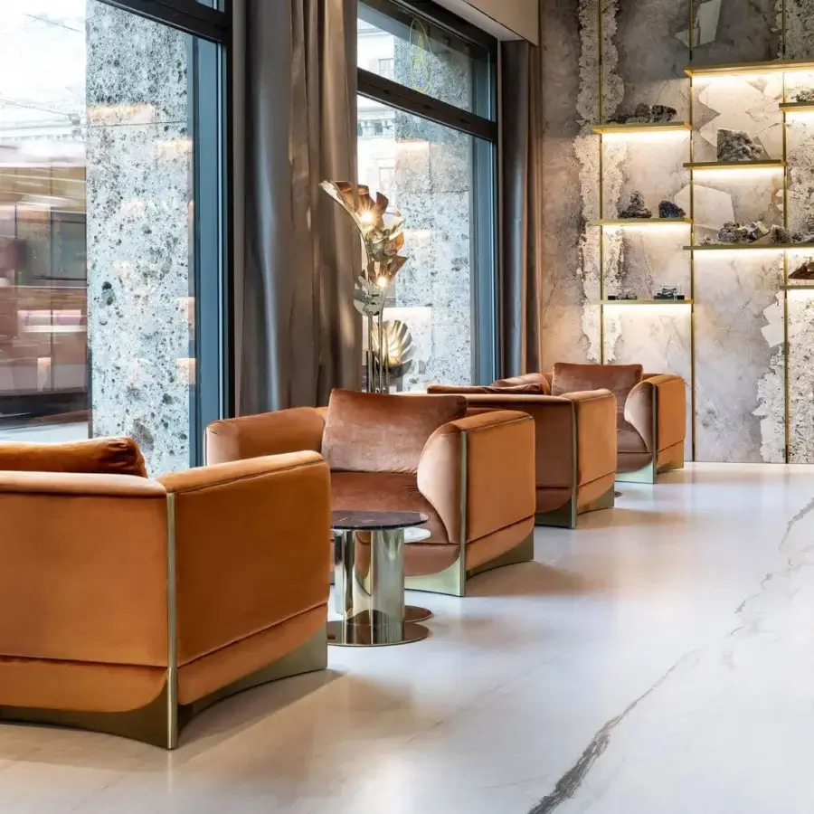 Captivating Visionnaire Ca’ Foscari lounge chair with sumptuous burnt orange velvet upholstery and polished stainless steel base