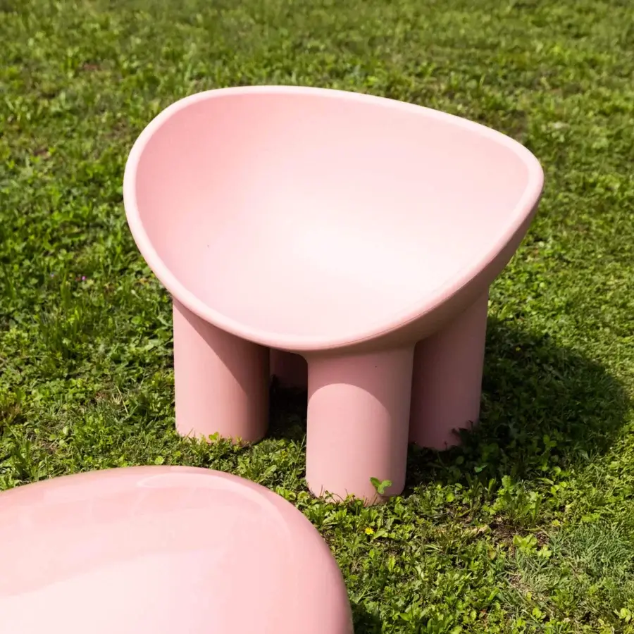Distinguished Driade Roly Poly lounge chair with a bowl-shaped seat and cylindrical legs in muted pink polyethylene with a smooth matte finish