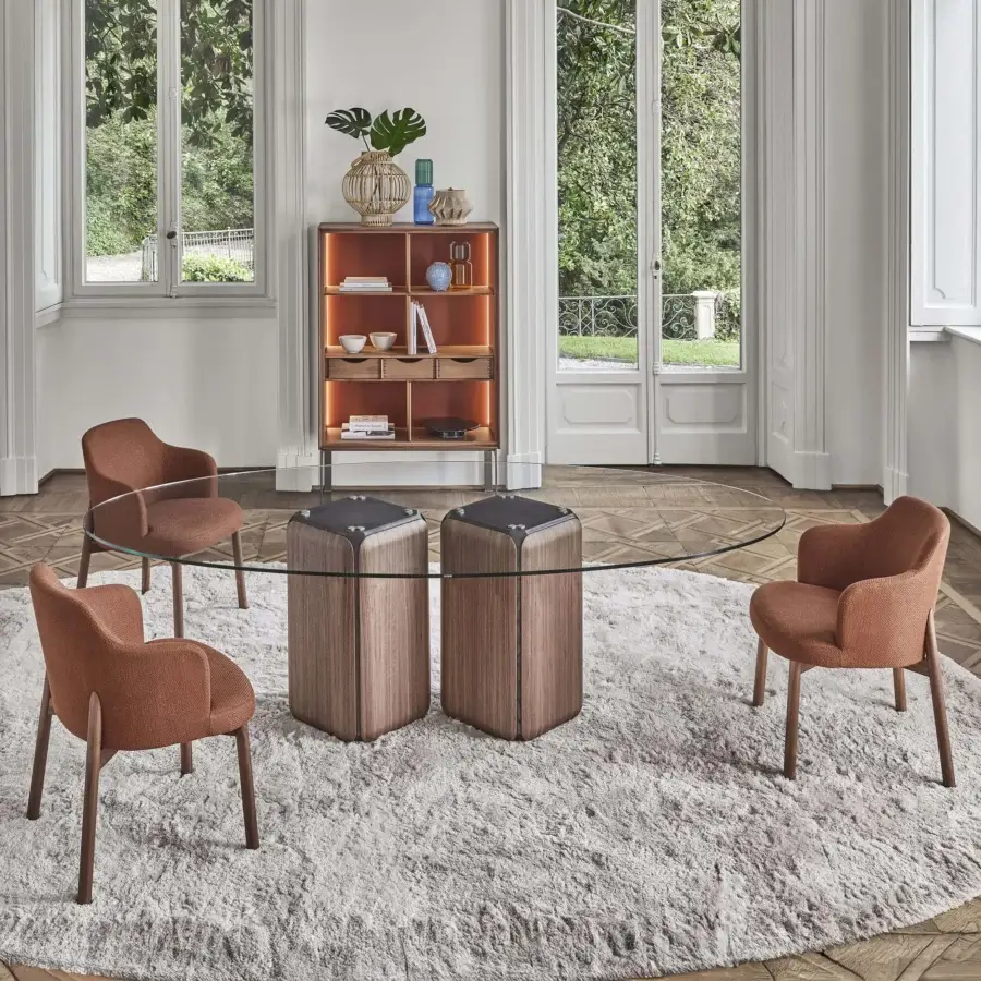 Distinguished Porada Bay table with transparent glass top and sculptural Canaletta walnut bases, finished with subtly greystained ash core