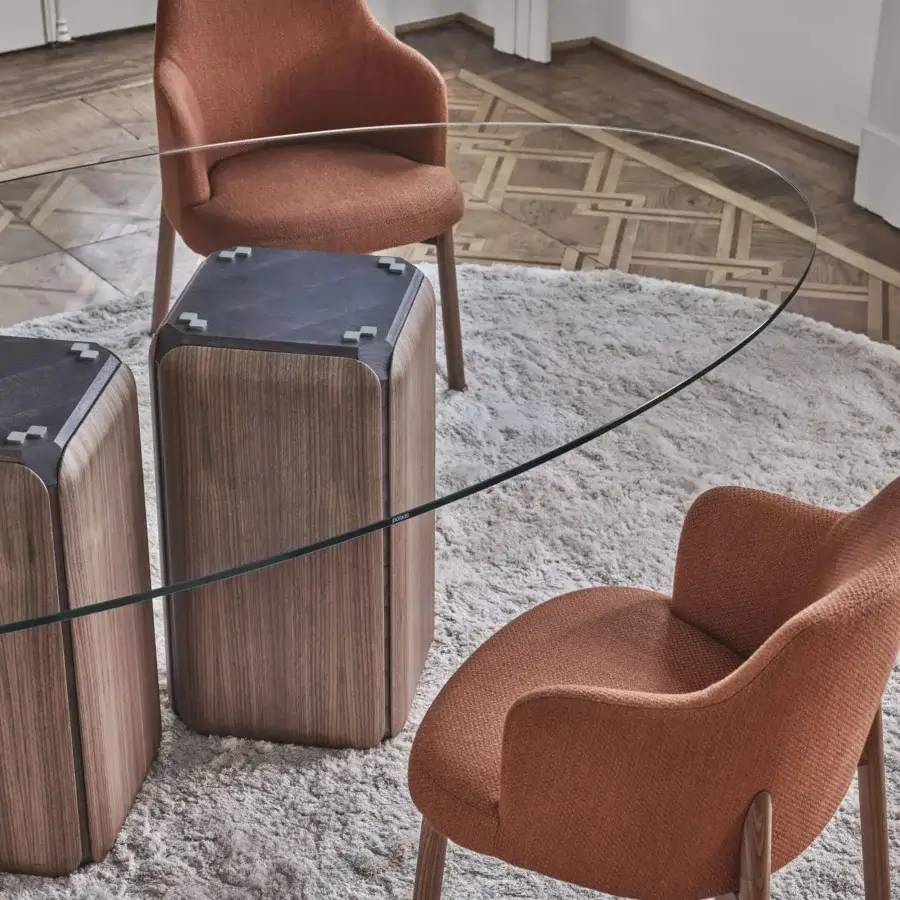 Distinguished Porada Bay table with clear glass and Canaletta walnut, exhibiting a satin finish and curved silhouette