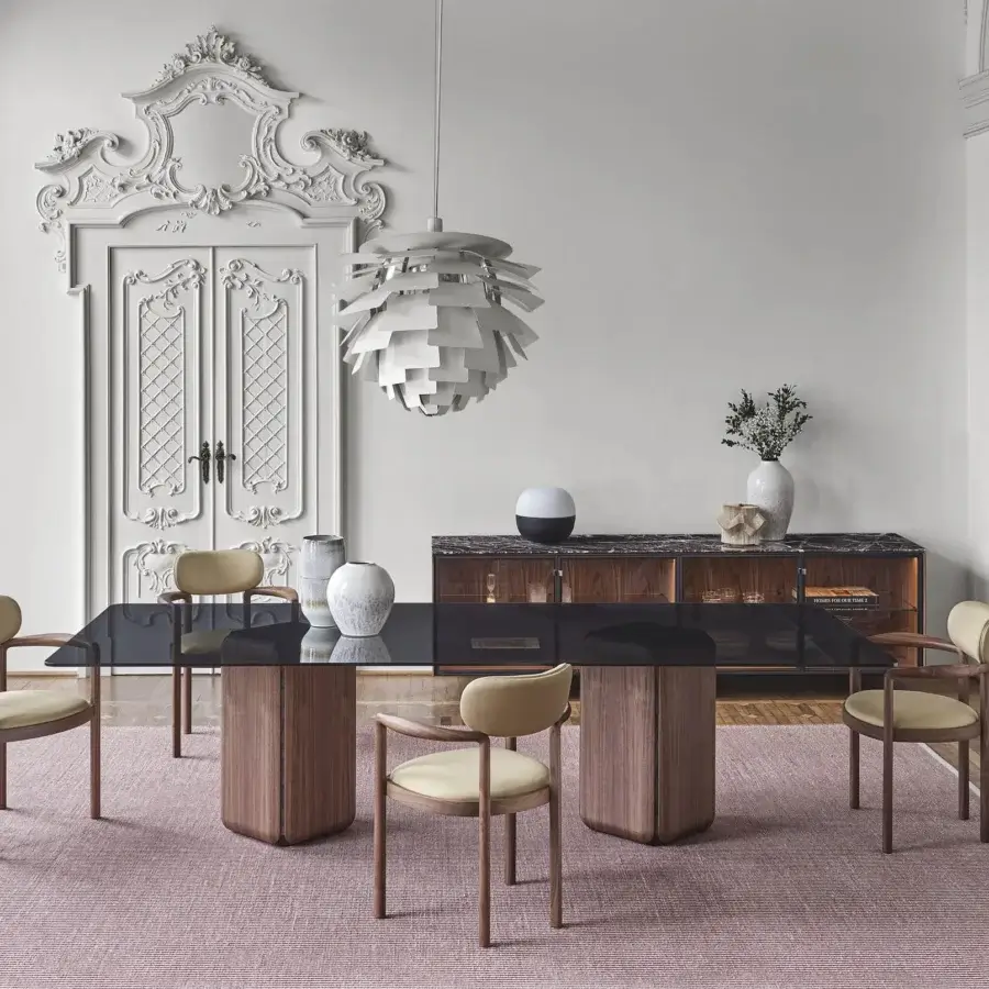 Distinguished Porada Bay table crafted in dark glass with a greystained ash core and Canaletta walnut bases with a satin finish
