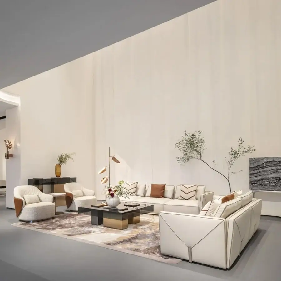 Exceptional Visionnaire Bastian sofa with creamy off-white fabric upholstery, contrasting leather detailing, satinized stainless steel friezes and lacquered feet