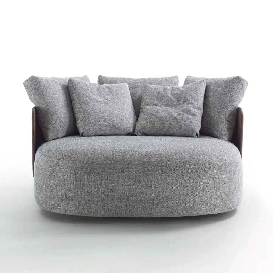 Sophisticated lounge chair with softly rounded form and muted gray textured upholstery built with a dark-toned wood frame