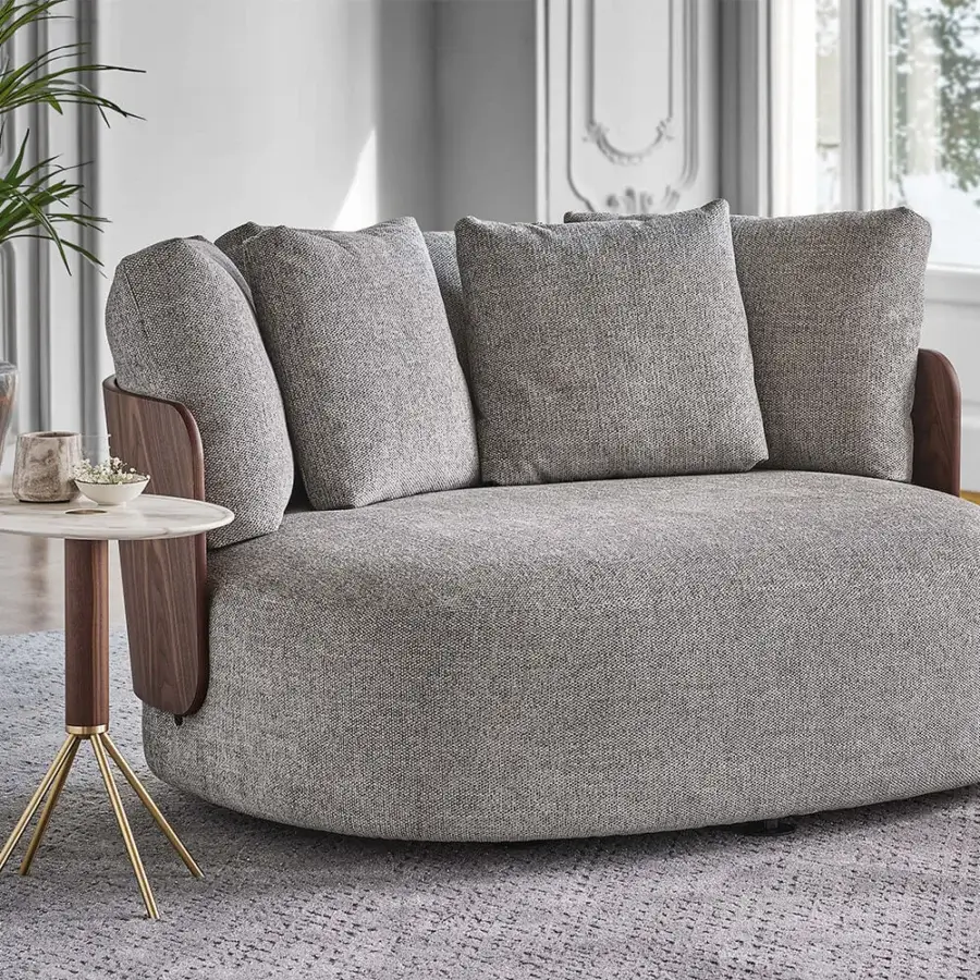 Distinguished Porada Calin XL lounge chair with curved Canaletta walnut backrest and plush gray textile upholstery with matte finish