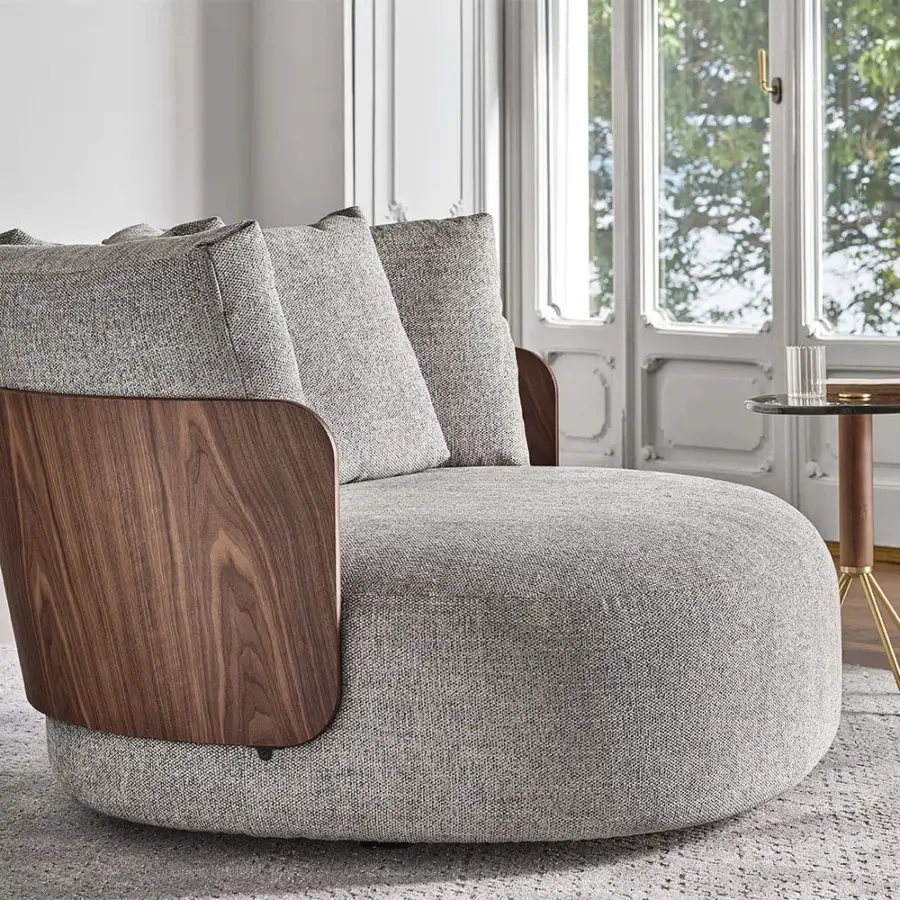 Sophisticated Porada Calin XL lounge chair with curved Canaletta walnut frame and neutral gray fabric upholstery with satin finish