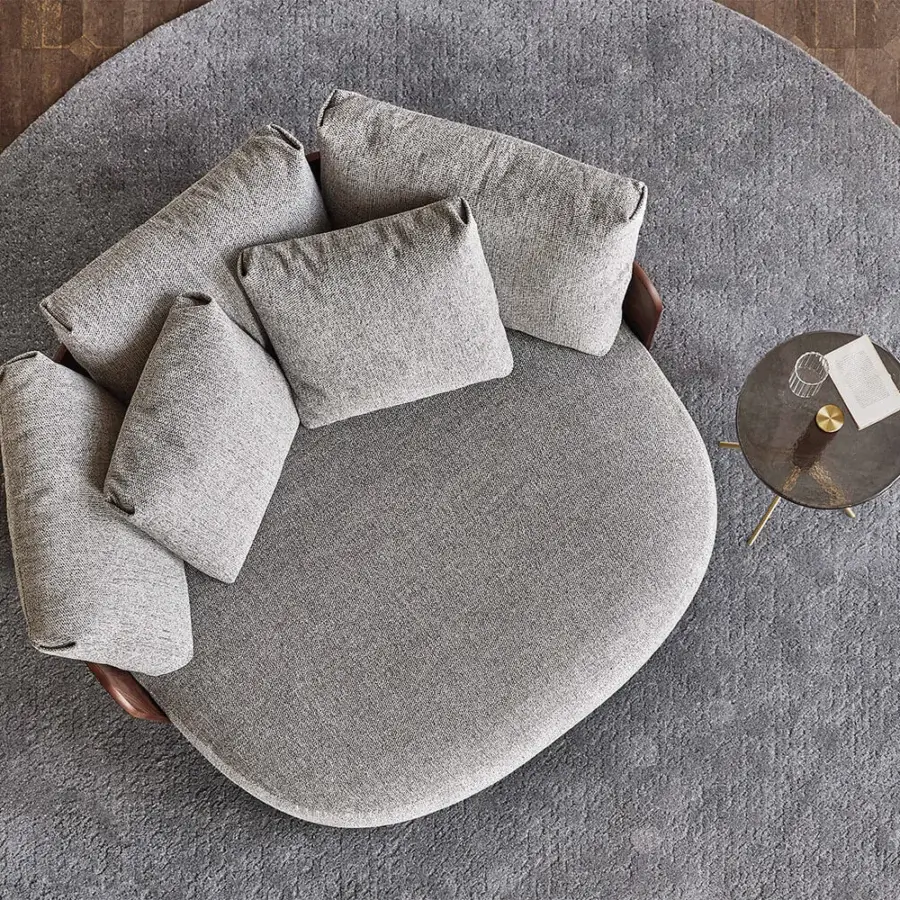 Exceptional Porada Calin XL lounge chair with gracefully curved Canaletta walnut backrest and plush gray textured textile upholstery