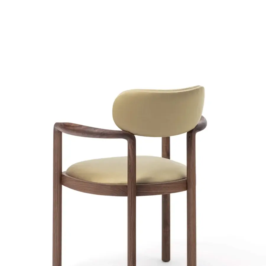 Distinguished Porada Dione chair reimagines a bucket seat crafted with solid canaletta walnut and muted olive green fabric with a satin finish