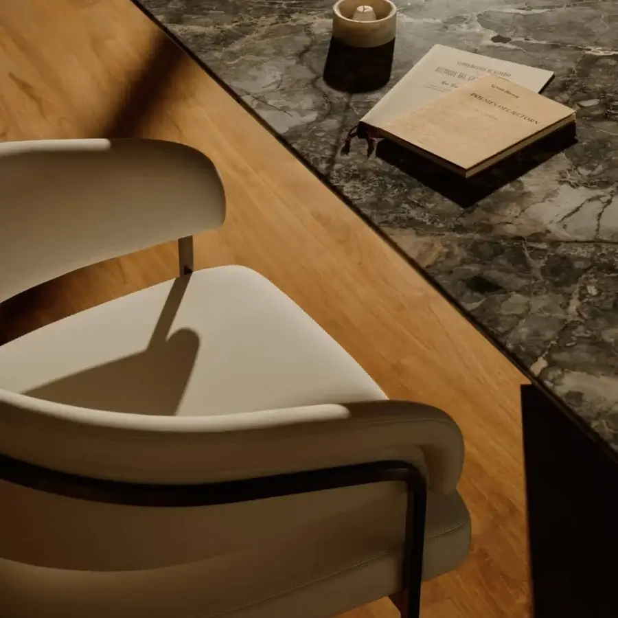 Superior Visionnaire Kerwan table with dark grey marble top, satin-finish wood, and polished stainless steel base