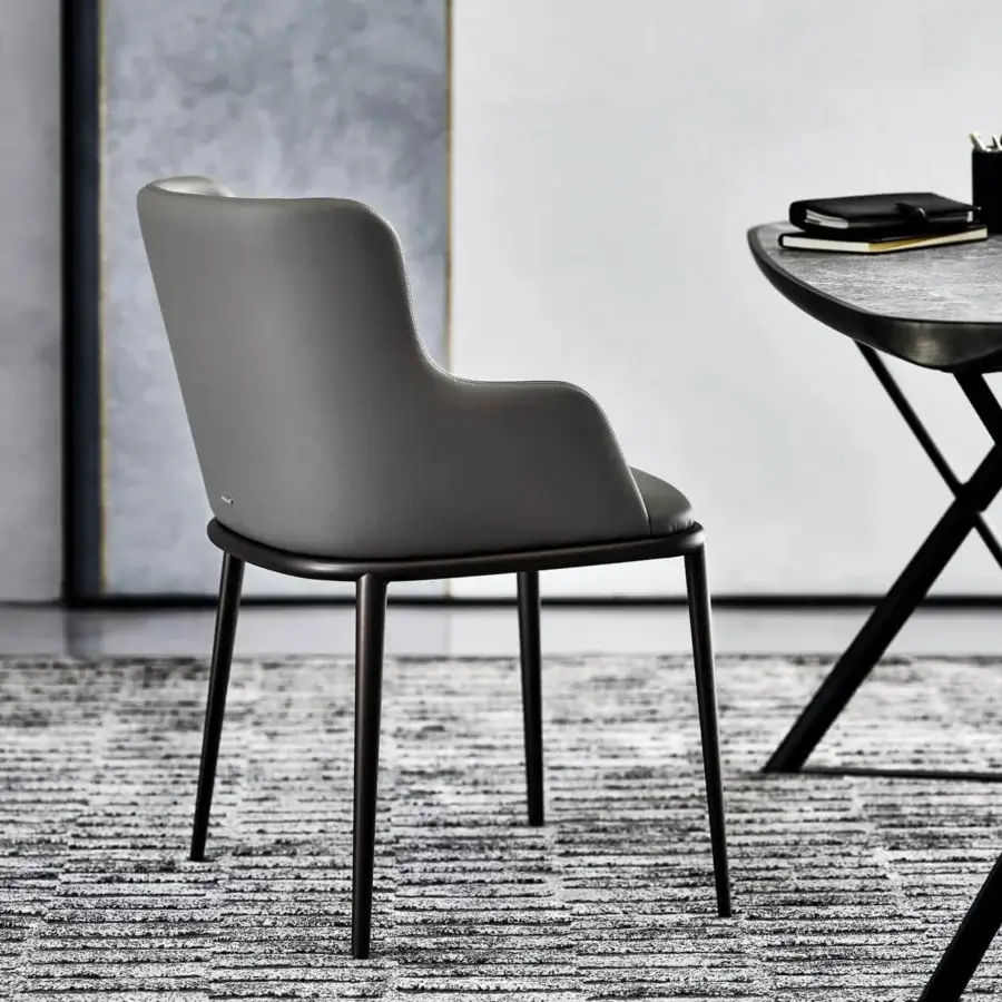 Distinguished Cattelan Italia Magda ML chair with enveloping backrest and wide seat in matte synthetic material with dark bronze legs