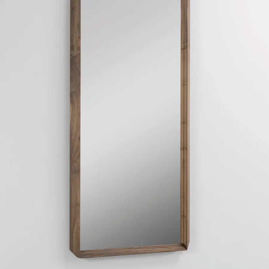 Distinguished Porada Fortyfive mirror crafted in solid canaletta walnut with a satin finish and sculptural 45-degree corner cuts