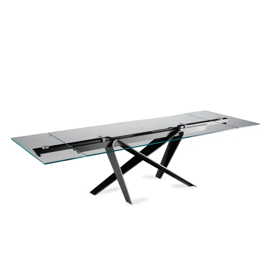 Elegant Naos double extendable dining table with a sleek glass tabletop and painted dark metal sculptural base