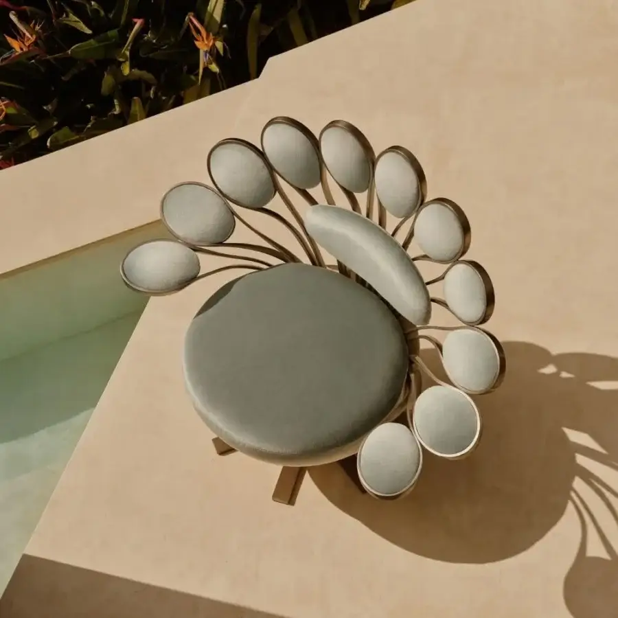 Distinguished Visionnaire Pavone Outdoor lounge chair with curved aluminum frame and muted gray textile upholstery with satin-finish metal edging