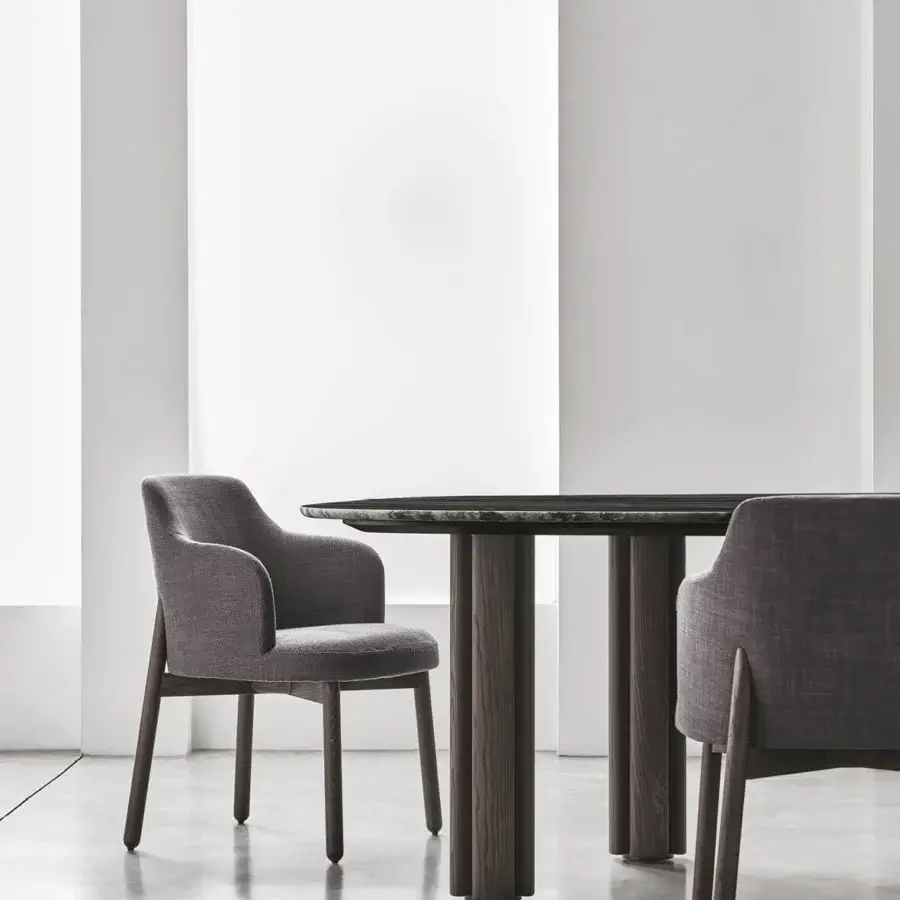Exceptional Porada Abby chair crafted with a solid Canaletto walnut frame and muted gray textile upholstery with a matte finish