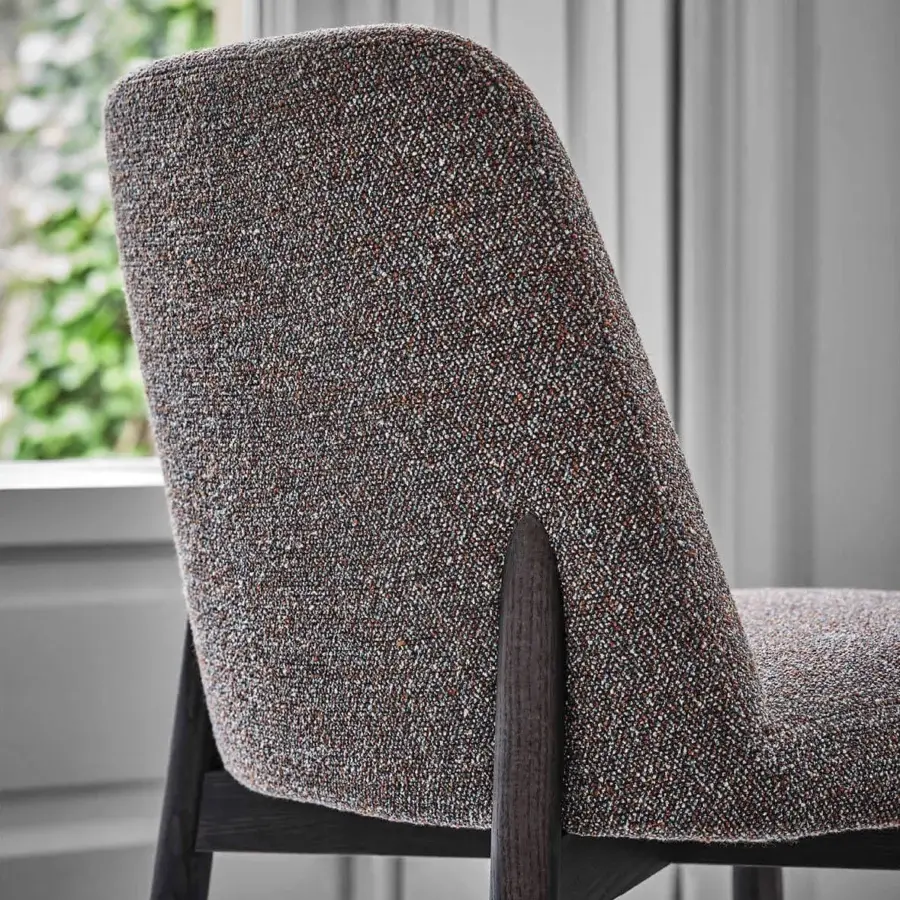 Distinguished Porada Abby chair with a gracefully curved Canaletto walnut frame and softly contoured seat upholstered in muted gray textile with satin finish