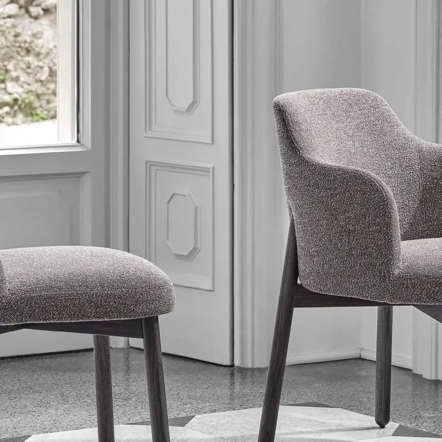 Distinctive Porada Abby chair with a gently curved Canaletto walnut frame and heathered gray textile upholstery
