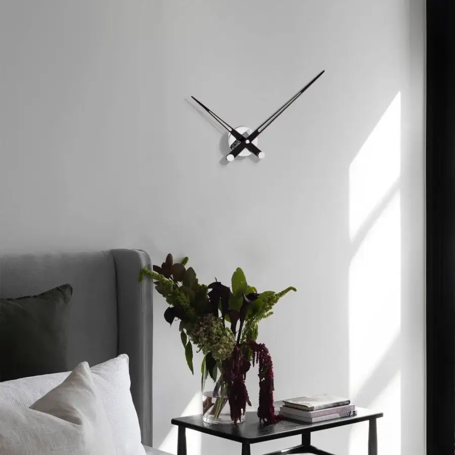 Sophisticated Nomon Axioma wall clock with a sleek circular form and slender hands in matte black metal