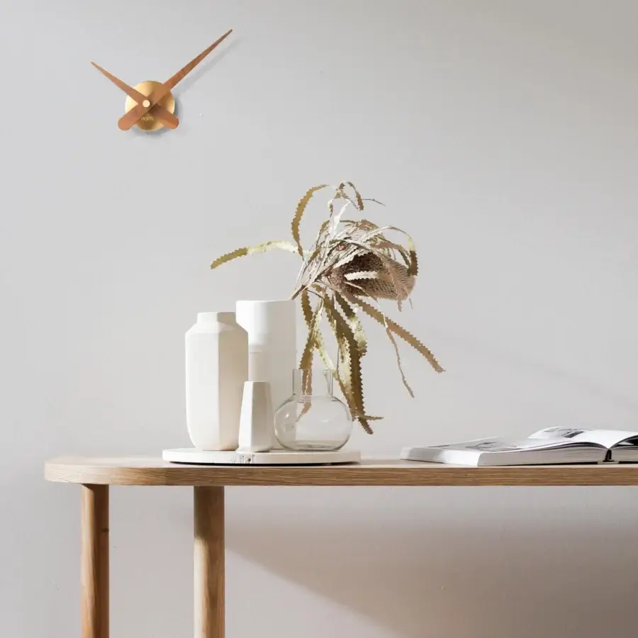 Exclusive Nomon Axioma wall clock crafted in metal with a warm muted bronze finish and subtle matte texture