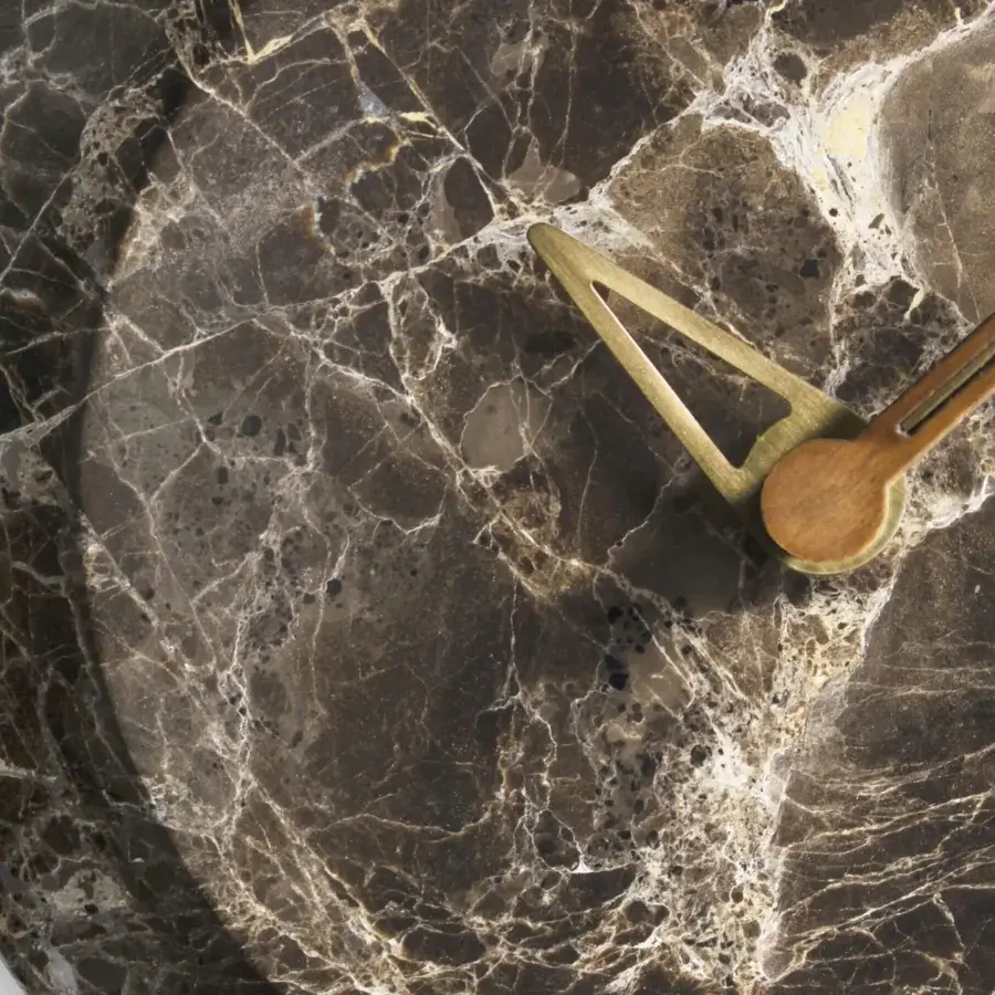 Exceptional Nomon Bari wall clock with a dark marble face, polished brass hands and warm walnut accents