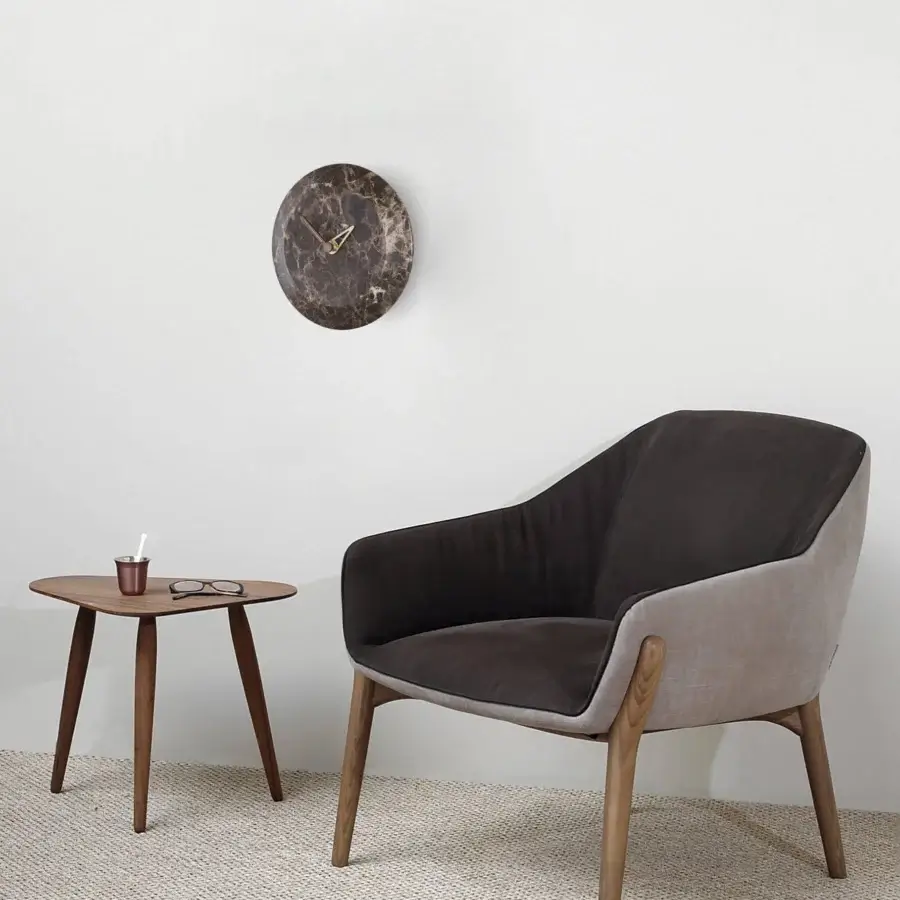 Elegant Nomon Bari wall clock with a marble face, polished brass hands and warm walnut casing