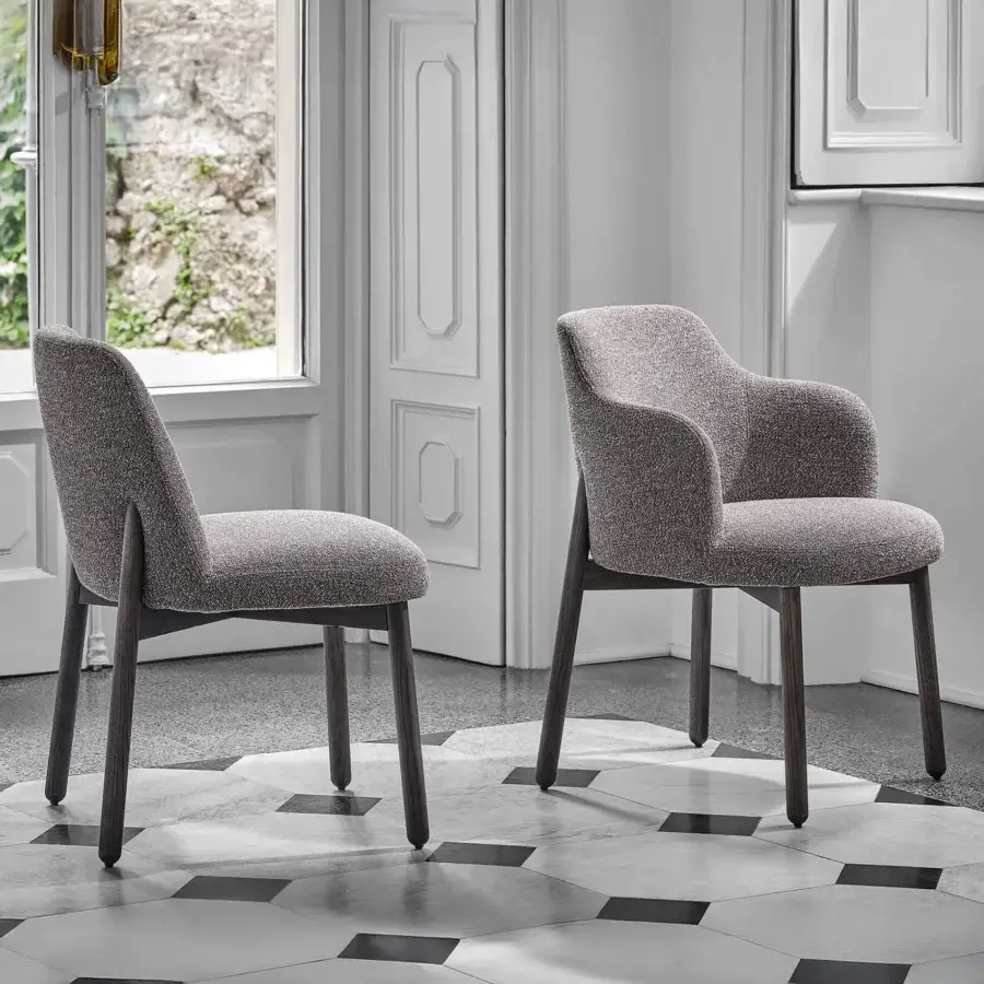 Distinguished Porada Abby chair with a gracefully curved Canaletto walnut frame and textured neutral gray upholstery in a satin finish