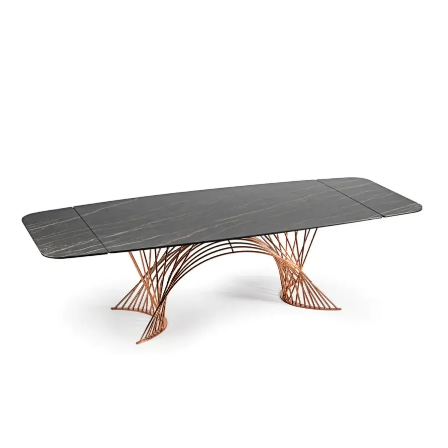 Elegant Naos Latour table with dark grey ceramic tabletop and warm copper painted metal base exhibiting a polished finish
