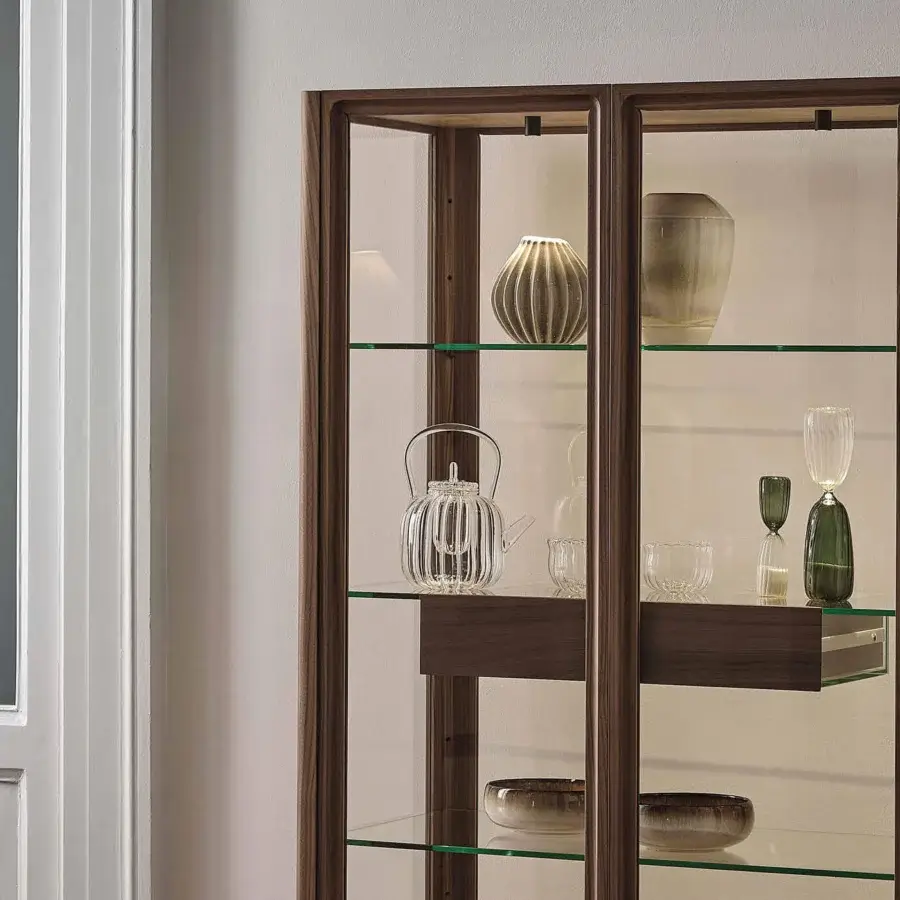 Distinguished Porada Atsuko cabinet with Canaletto walnut frame, clear glass shelves and Cuoietto leather lining with matte black metal base