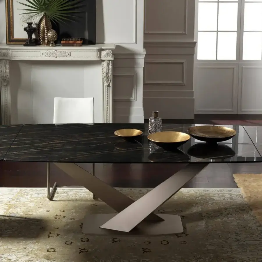 Distinguished Naos Zeus extendable dining table with a polished dark ceramic top and sculptural painted metal base