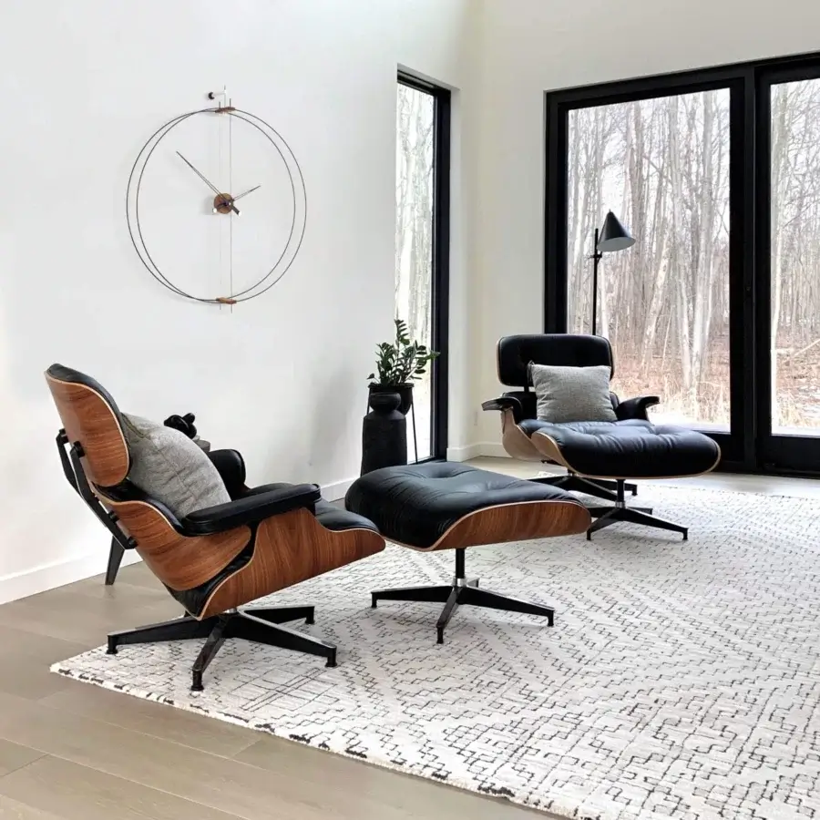 Elegant Nomon Barcelona wall clock with a double ring in black fiberglass and warm walnut elements with metallic accents and matte finish