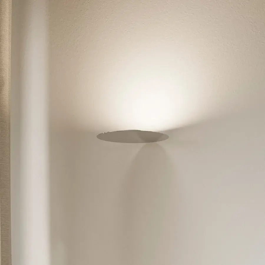 Elegant Luceplan Millimetro wall lamp with mirror-finish metal and a low-profile light gray aesthetic delivers warm illumination