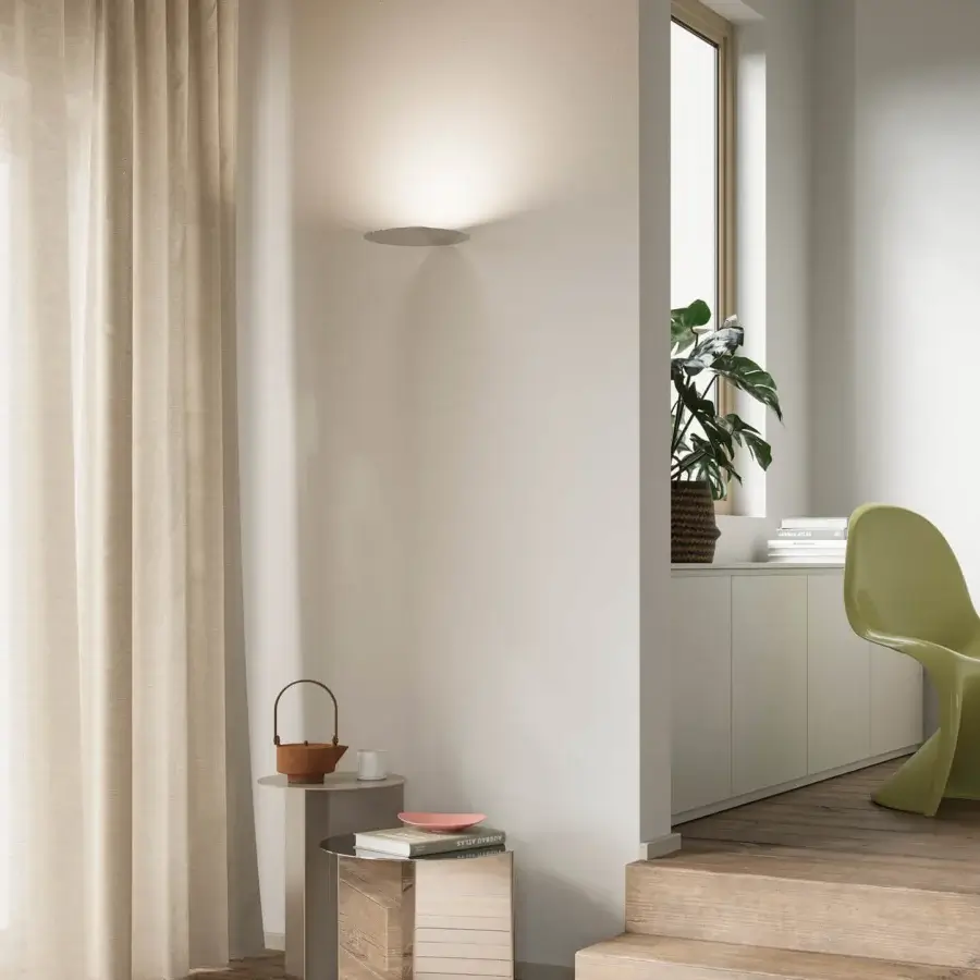 Distinguished Luceplan Millimetro wall lamp crafted in polished mirror-finish metal delivers concealed illumination with a warm glow