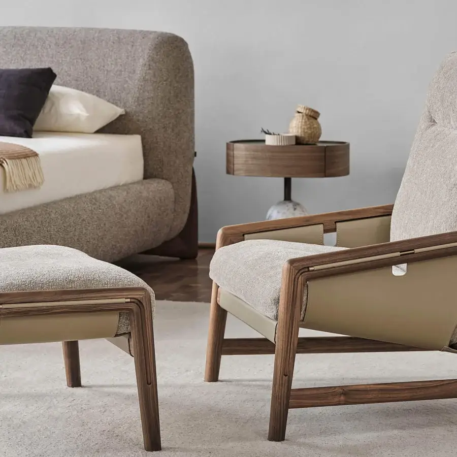 Lavish Porada Bice armchair with Canaletto walnut frame and textured neutral gray Cuoietto leather upholstery in satin wood finish