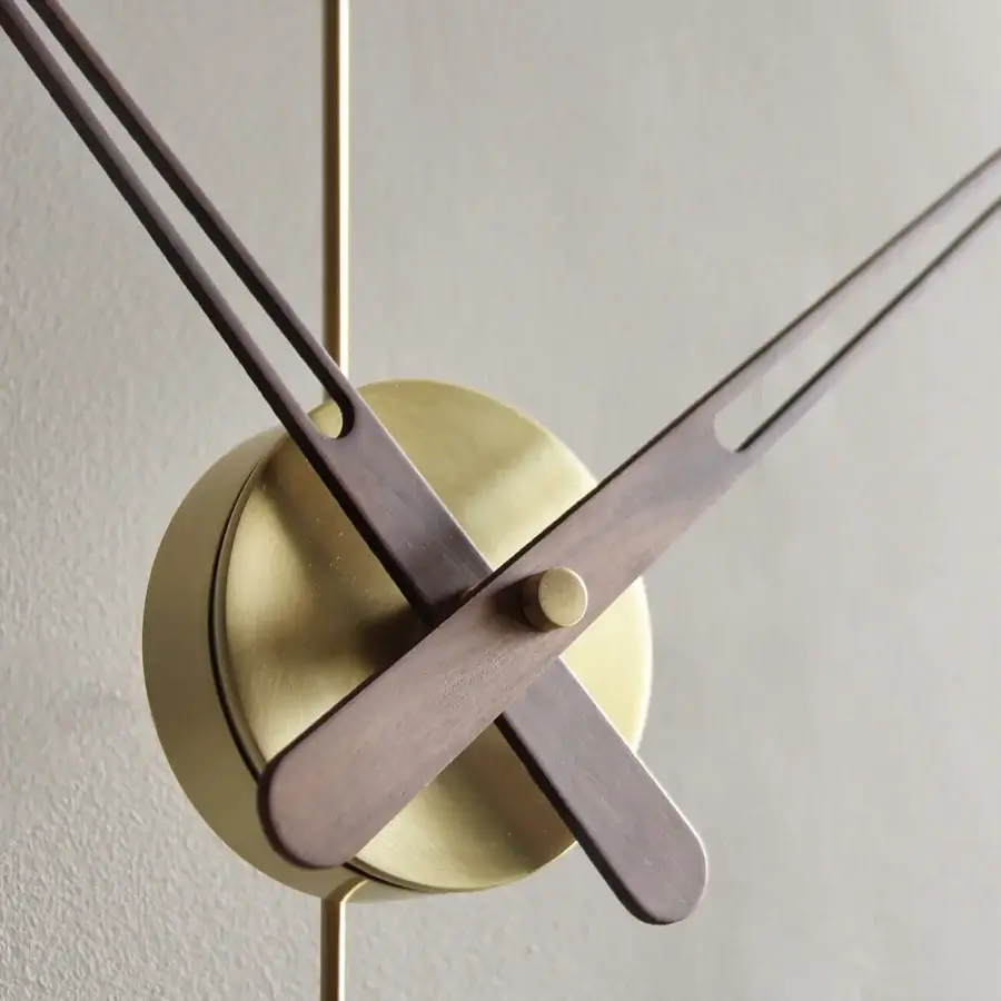 Elegant Nomon Mini Barcelona wall clock in black fiberglass, walnut, and brushed gold metallic details with delicate hands