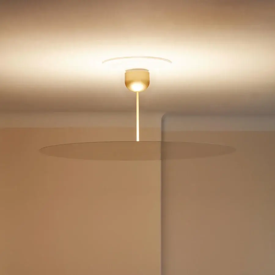 Distinguished Luceplan Millimetro suspension lamp in warm white with a smooth satin metal finish and upward illumination