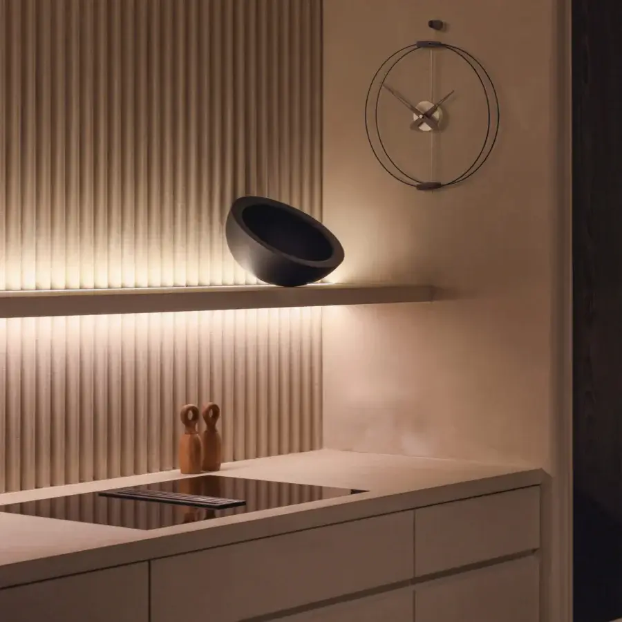 Distinguished Nomon Micro Barcelona wall clock with a black fiberglass double ring framing elegant walnut elements and a dark gray finish