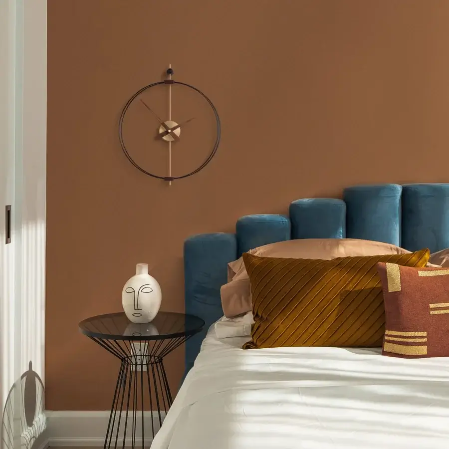 Elegant Nomon Micro Barcelona wall clock with a black fiberglass double ring framing walnut elements and fine metal details with a matte finish