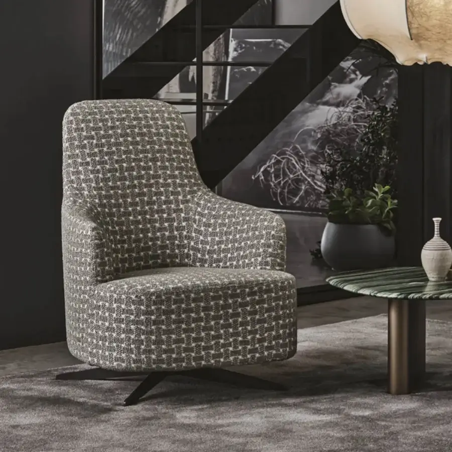 Sophisticated Porada Copine Bergere armchair with muted gray textured textile upholstery and dark metal swiveling base