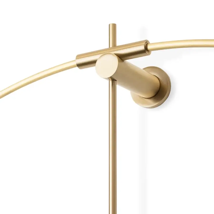 Elegant Nomon New Anda wall clock with a suspended metal ring and warm gold satin finish