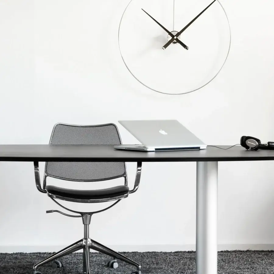 Exceptional Nomon New Anda wall clock with a light face, slender hands and polished metallic ring design