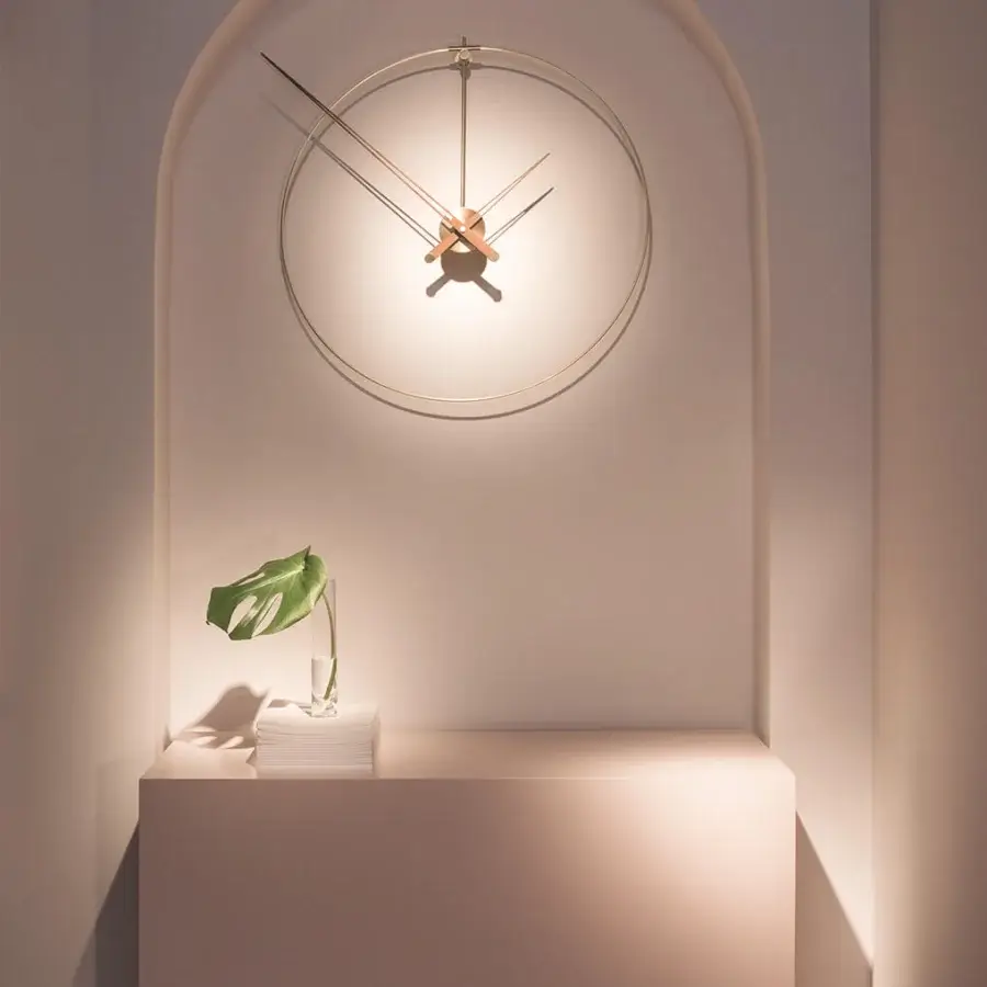 Superior Nomon New Anda wall clock crafted in pale beige metal with a matte finish and balanced curved forms