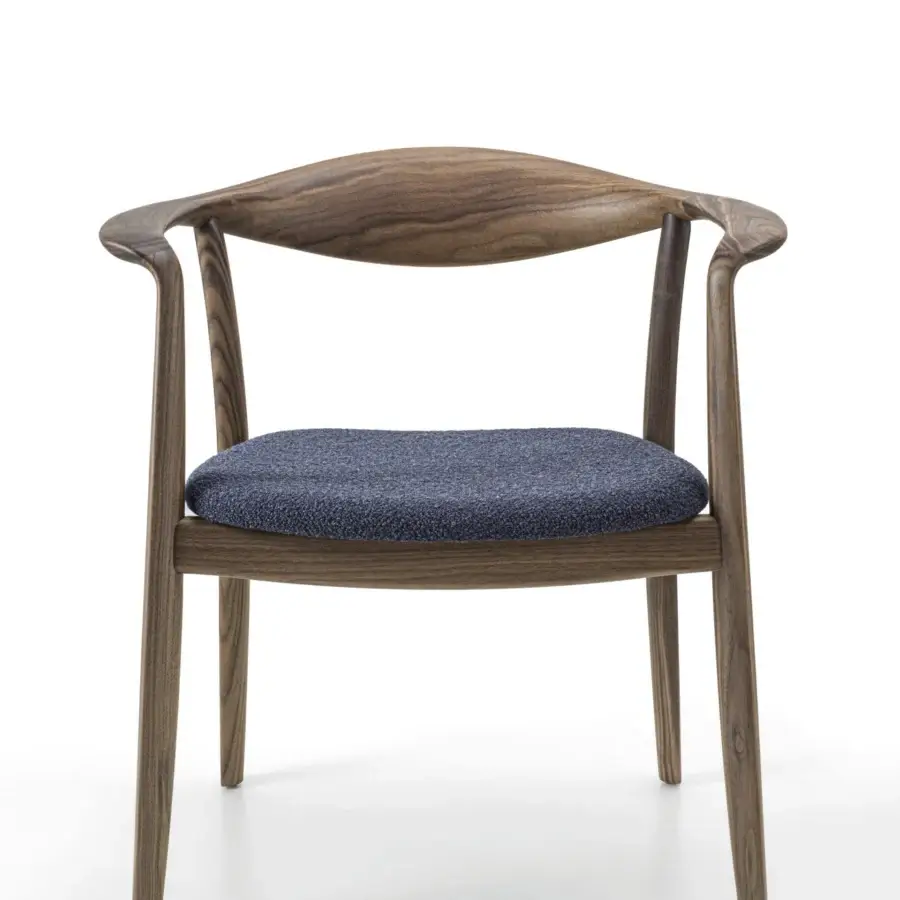 Elegant Porada Frida armchair with sculpted canaletto walnut frame and dark blue textured upholstery finish