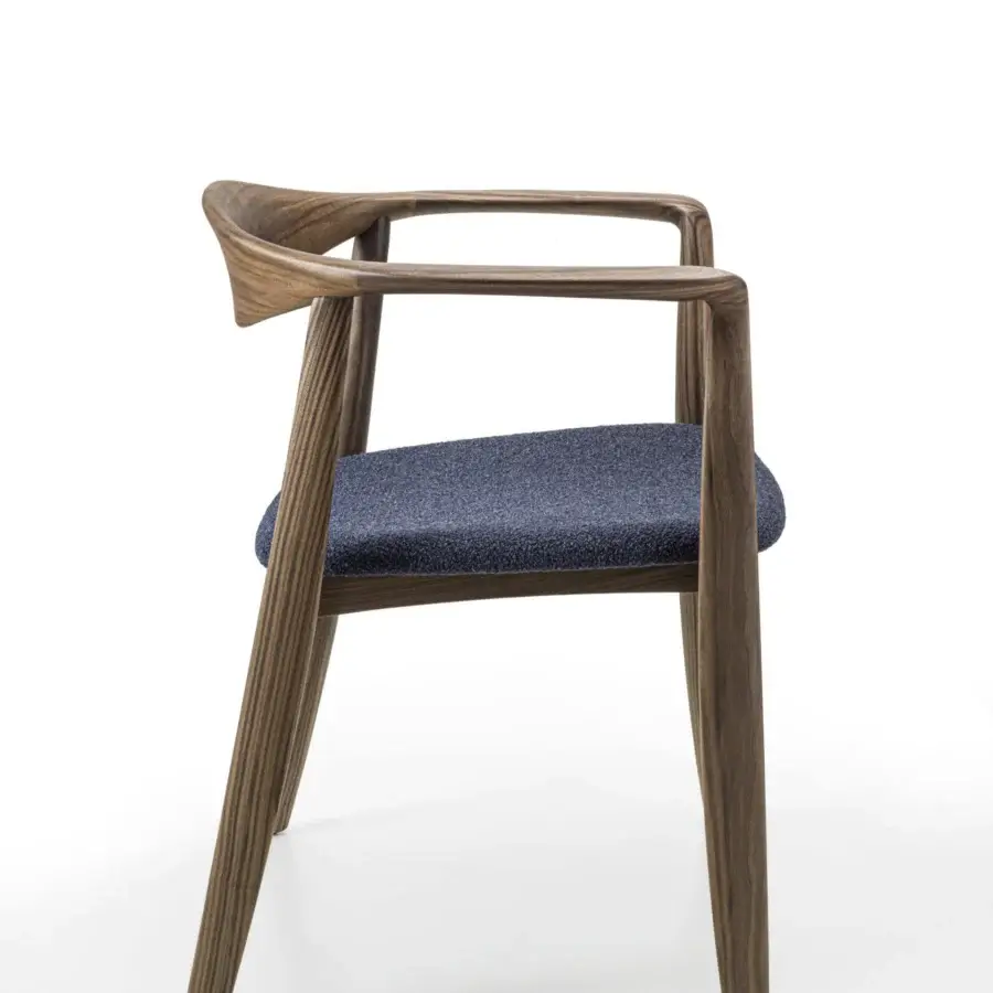 Distinguished Porada Frida armchair with sculpted solid canaletto walnut frame and textured dark blue fabric upholstery with satin finish