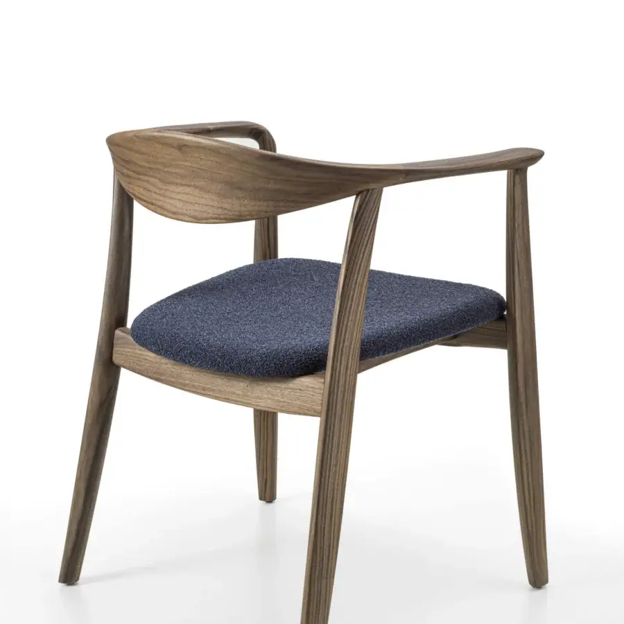 Elegant Porada Frida armchair with sculpted solid canaletto walnut frame and dark blue textured textile seat in satin finish