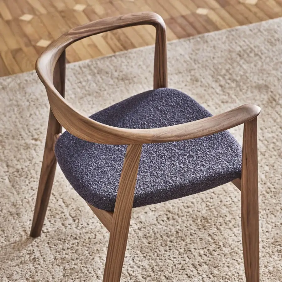 Distinguished Porada Frida armchair with sculpted solid canaletto walnut frame and dark gray-blue upholstery in satin finish