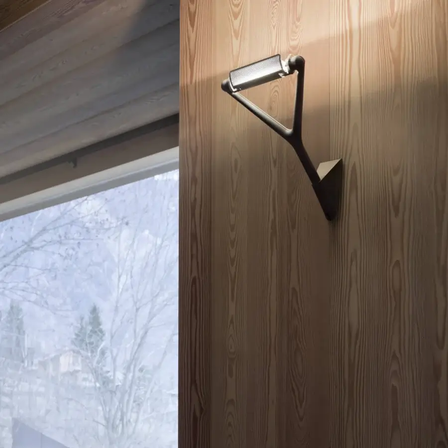 Distinguished Luceplan Lola wall lamp with angular steel construction and matte black finish allowing precise adjustments