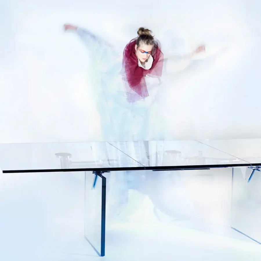 Elegant Naos Quasar table crafted with a clear glass top and stratified glass legs with a glossy finish