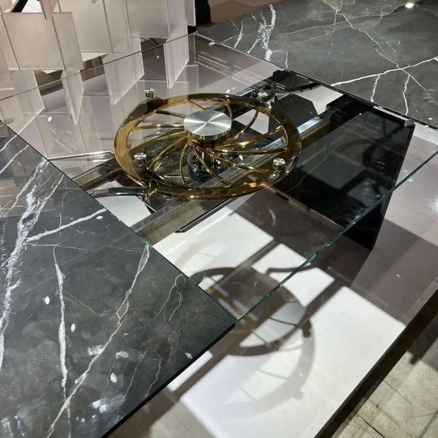 Distinguished Naos Quasar table crafted with glossy dark marbled glass, polished golden metal, and stratified glass legs