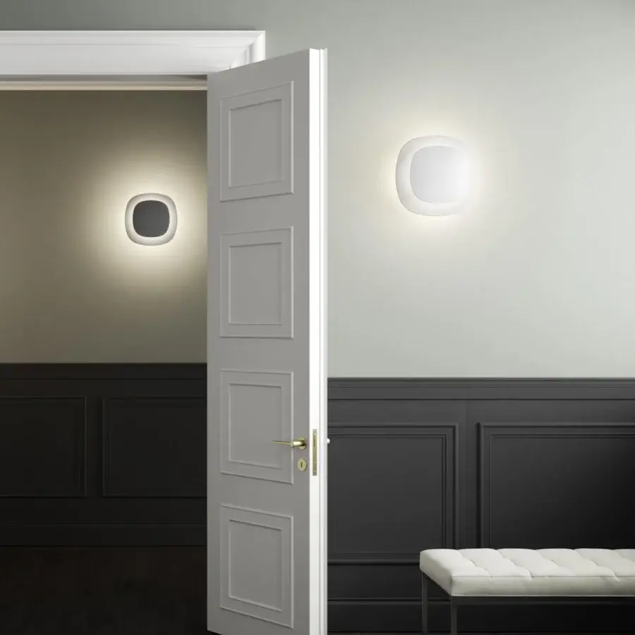 Distinguished Luceplan Luthien wall lamp crafted in technopolymer with a refined white aluminum finish delivering atmospheric indirect light