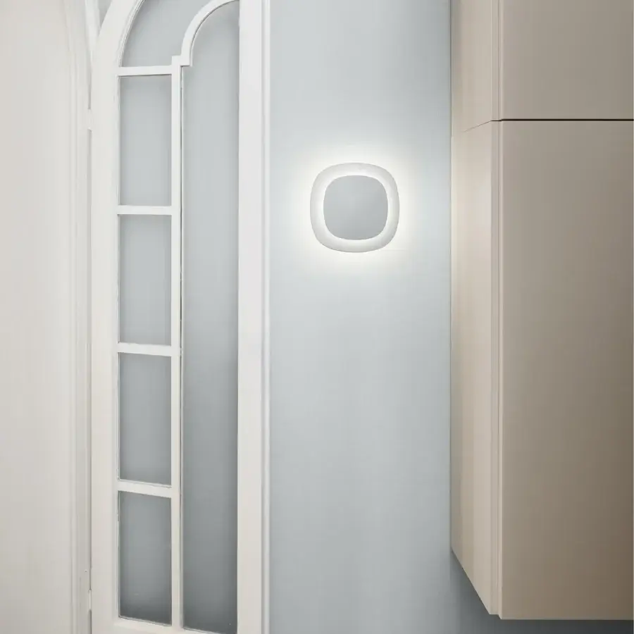 Elegant Luceplan Luthien wall lamp crafted in technopolymer with a refined white aluminum finish delivering atmospheric light