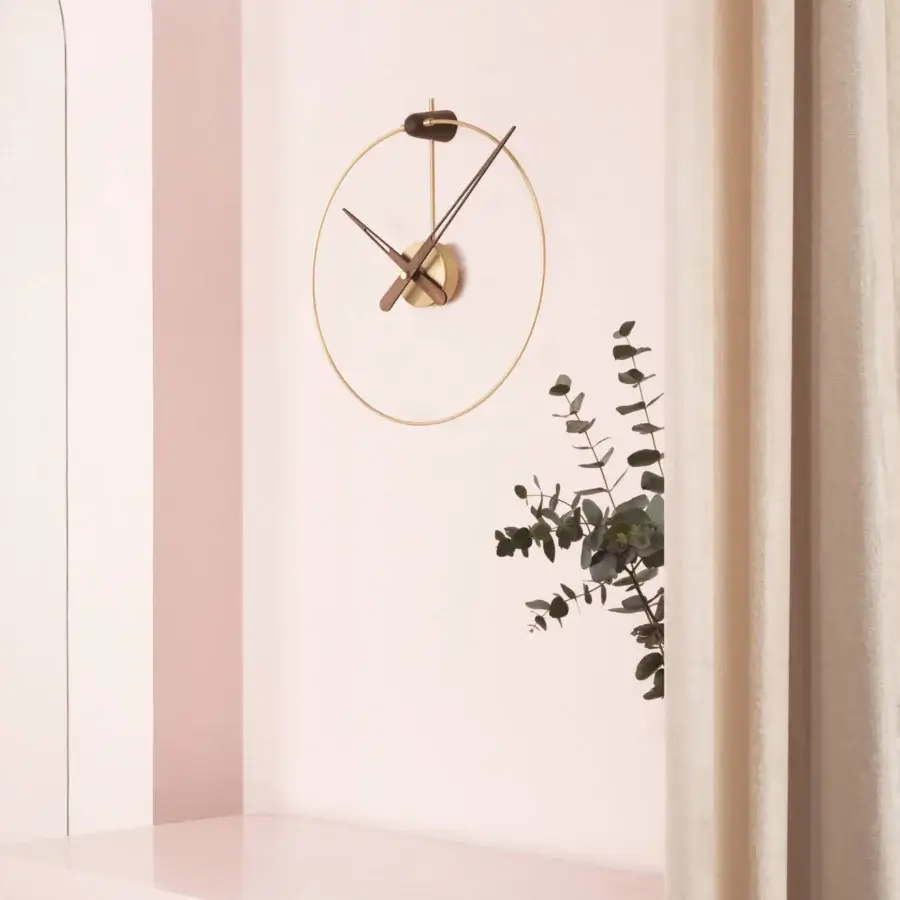 Distinguished Nomon Micro Anda wall clock crafted with a slim metallic ring and contrasting walnut wood hands in golden finish